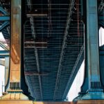 low-angle-shot-big-blue-metal-bridge-sunny-day_181624-2755